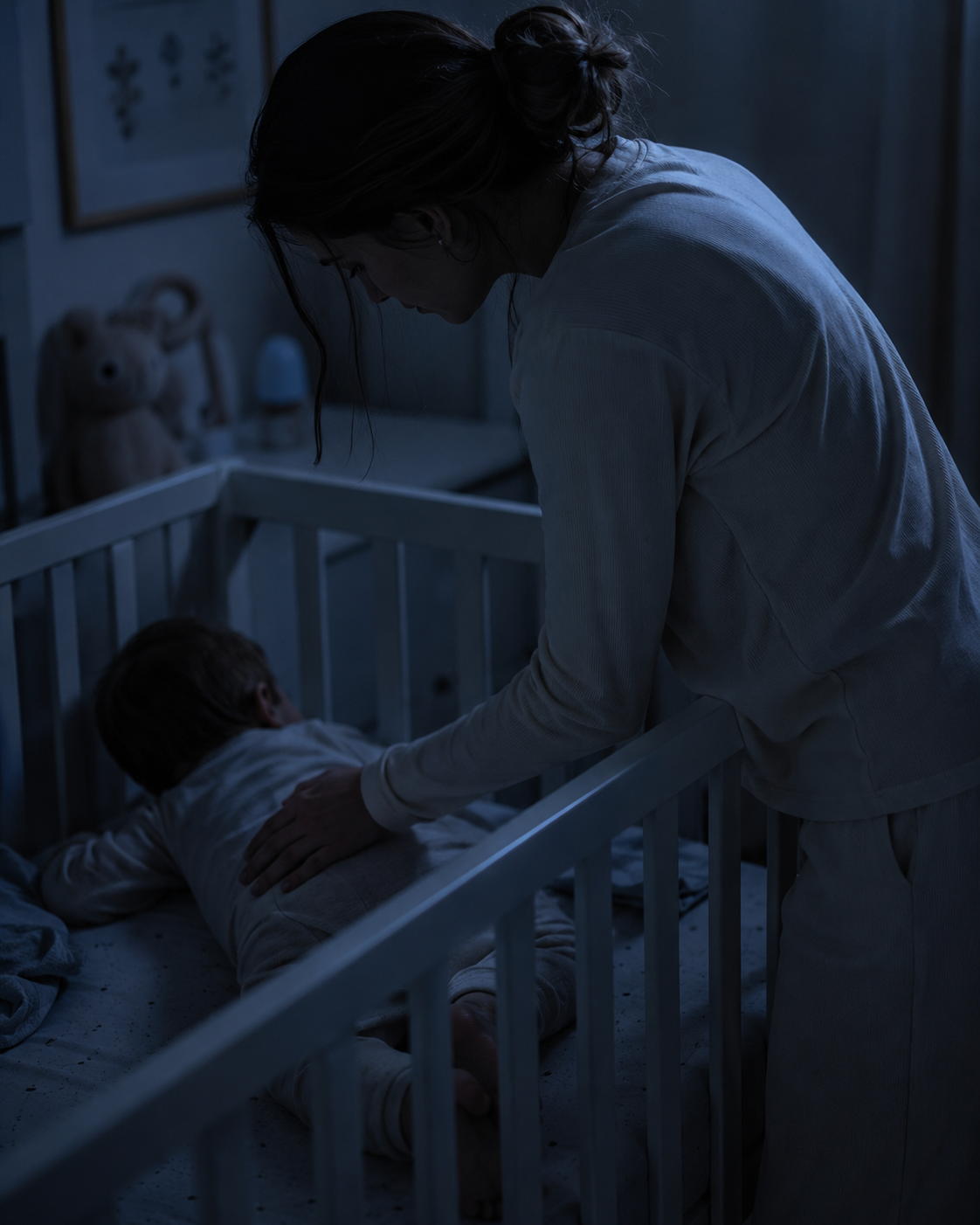 Before — mother comforting baby in crib late at night